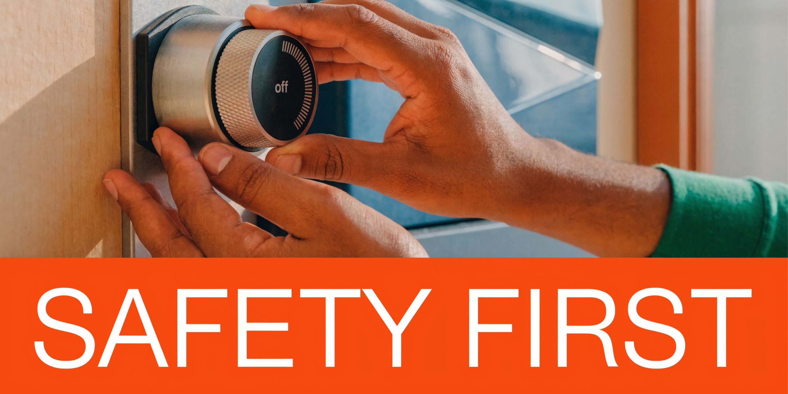 A close-up view of a person's hand turning a furnace control knob to the off position.