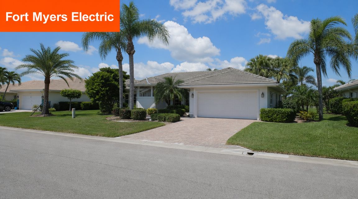 A scenic view of a well-maintained residential home with palm trees and a paved driveway in Florida.